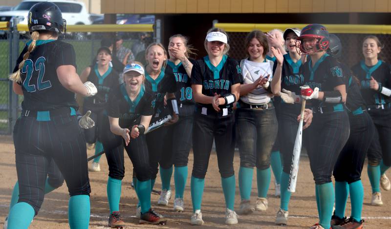 Woodstock North’s Thunder prepare to greet Casey Vermett on her second of two home runs against Jacobs in varsity softball at Algonquin Friday night.
