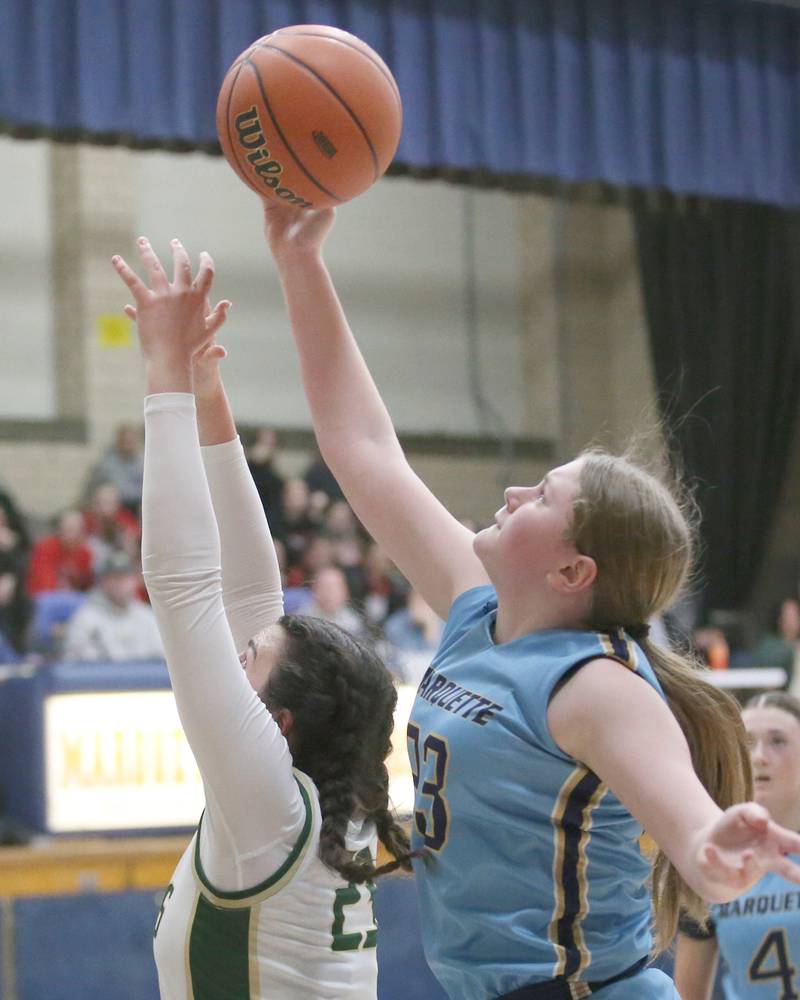 Marquette's Kesley Cuchra grabs a rebound over St. Bede's Ali Bosnich during the Class 1A Regional semifinal game on Monday, Feb,. 12, 2024 in Bader Gym.