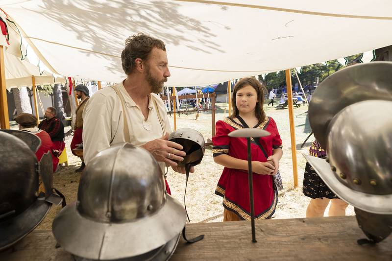 Abel Joudrell educates Benjamin Frazer, 11, on historic helms Sunday, October 5, 2025, at the Olde English Faire in Oregon.
