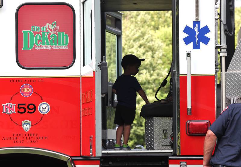 Visitors check out the interior of a DeKalb fire truck Thursday, July 21, 2022, during the DeKalb Chamber of Commerce Family Fun Fest at Hopkins Park in DeKalb.