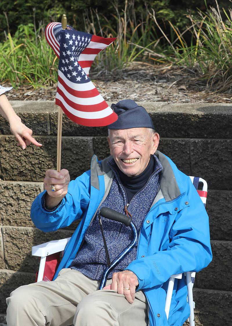 U.S. Air Force veteran Gene Faut waves the American Flag during a "No Kings” protest rally on Saturday, Oct. 18, 2025, along Route 31 in McHenry. The protest drew thousands of protesters to the area to protest the policies of President Donald Trump.