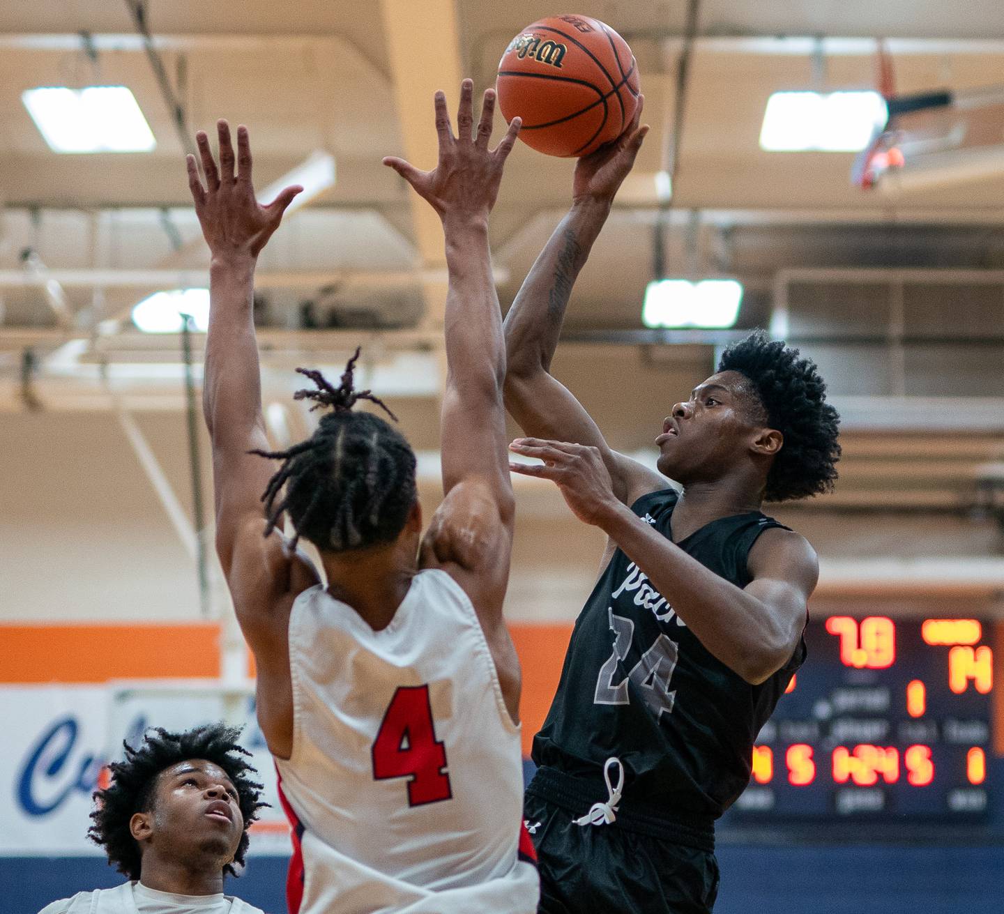Oswego East's Mekhi Lowery (24) shoots the ball in the post against West Aurora's Joshua Pickett (4) during the hoops for healing basketball tournament at Oswego High School on Friday, Nov 25, 2022.