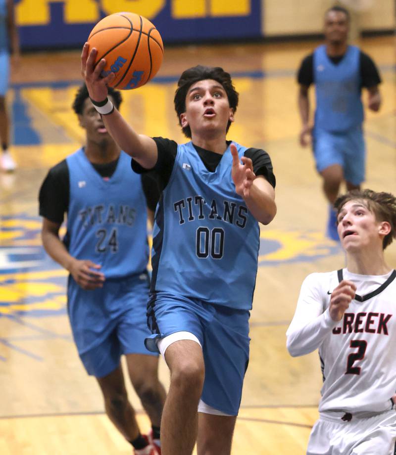 IMSA’s Neil Sitapara gets to the basket ahead of Indian Creek's Jason Brewer Friday, Feb. 6, 2026, during their Little 10 Conference championship game at Somonauk High School.