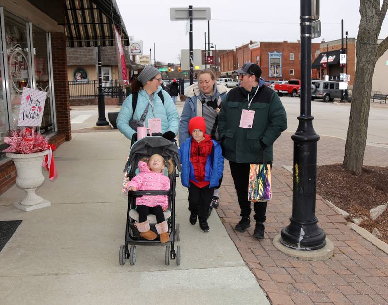 The Taylor family walks down Main Street as they participate in the 8th Annual Chocolate Walk for Charity in Oswego on Saturday, Feb. 8, 2025.