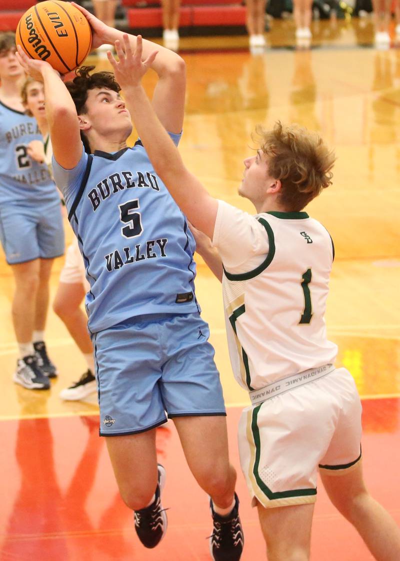 Bureau Valley's Logan Philhower eyes the hoop as St. Bede's Kaden Newman defends during the 50th annual Colmone Classic on Thursday, Dec. 12, 2024 at Hall High School.
