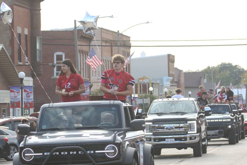Hall junior attendants Nina Zamora and Evan Vecchia ride during the Homecoming parade on Thursday, Sept. 18, 2025 downtown Spring Valley.