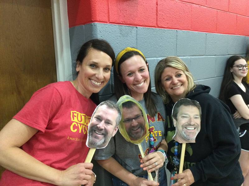 Teachers at O'Neill Middle School in Downers Grove hold cutouts of retiring principal Matt Durbala's head during a recent retirement celebration. Durbala is leaving Downers Grove Grade School District 58 after nearly two decades of service. (Courtesy of District 58.)