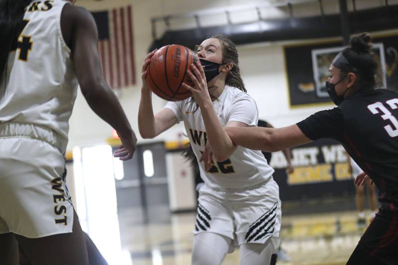 Joliet West's Grace Walsh is fouled on a shot on Saturday, March 13, 2021, at Joliet West High School in Joliet, Ill.