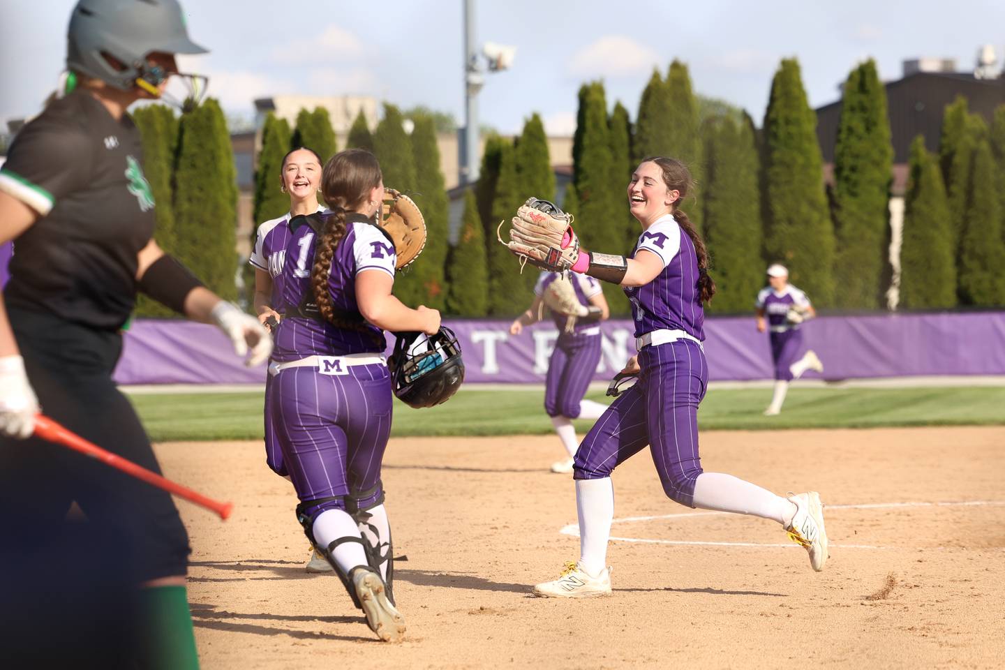 Manteno's Mady Dye runs to high five catcher Maddy Kvasnicka after throw down to first base for an out during Manteno's 11-1 loss to Seneca on Friday, May 8, 2026.