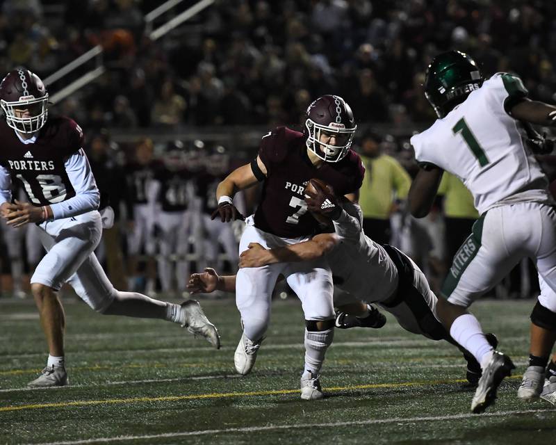 Lockport's running back Ty Schultz (7) tries to break free from a Glenbard West defender during class 8A second round playoffs on Saturday, Nov. 6, 2021, at Lockport High School in Lockport.