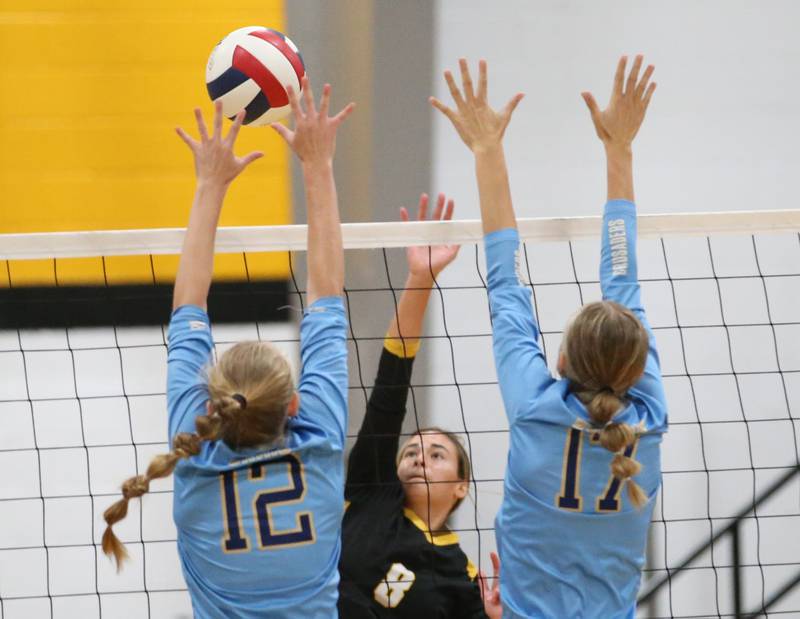 Marquette's Lilly Craig and teammate Avery Durdan block Putnam County's Ava Hatton on Thursday, Sept 7, 2023 at Putnam County High School.