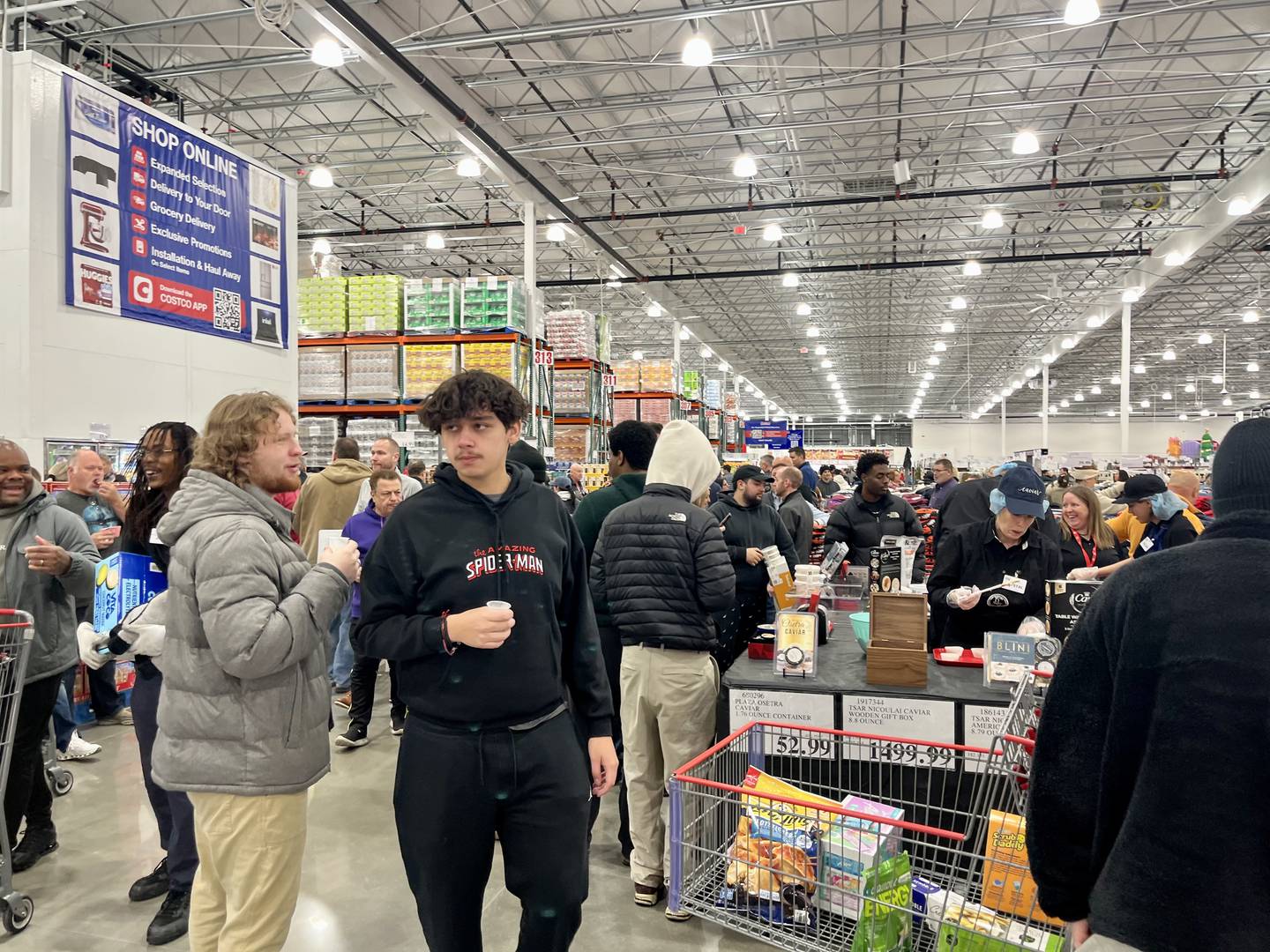 Shoppers try free food samples at the Costco Yorkville grand opening on Nov. 12, 2025.