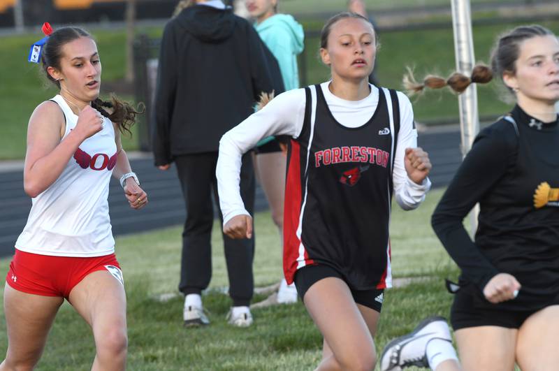Forreston-Polo's Tenlei Patterson (center) and Oregon's Anya Anaya (;eft) chase Lena-Winslow's Lila Grindey on the final curve of the 800 meters at the 1A Winnebago Sectional on Wednesday, May 13, 2026.