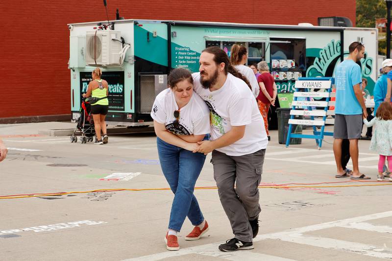 Magpie Renninger and Curtis Fuller enjoyed their Saturday, Sept. 20, 2025, afternoon by dancing in the streets to one of the street musicians playing at Morrison's Paint the Town event.