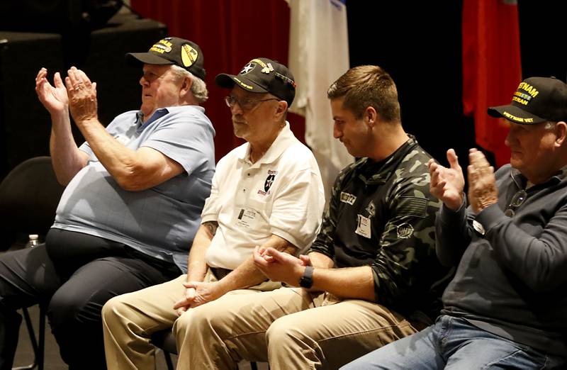 Veterans and students clap for U.S. Army veteran Robert 'Bob' Haynes during the Veterans Day event on Monday, Nov.11, 2023, at the Upper Campus of McHenry High School.