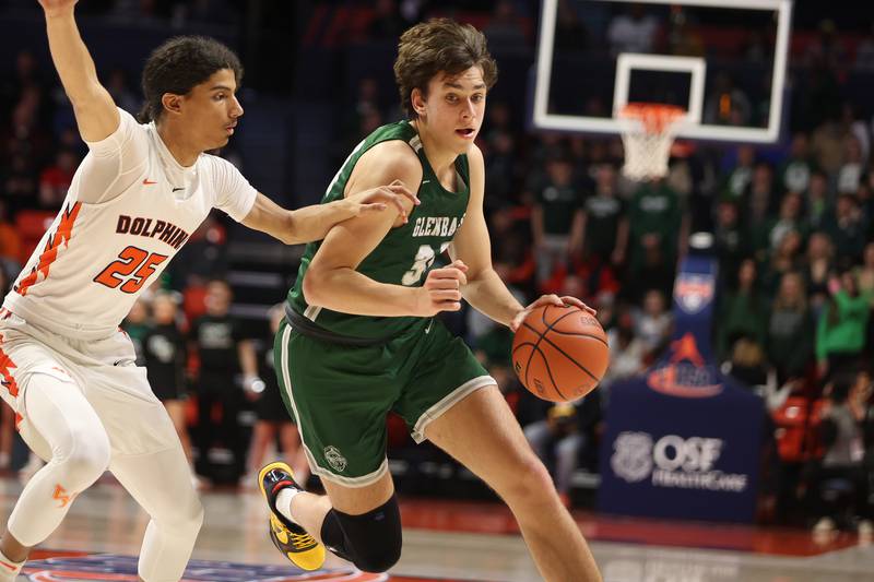 Glenbard West’s Braden Huff drives to the basket against Whitney Young in the Class 4A championship game at State Farm Center in Champaign. Saturday, Mar. 12, 2022, in Champaign.