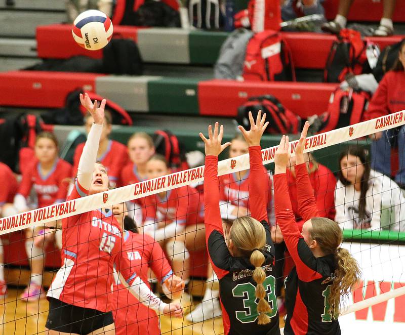 Ottawa's Addison Duggan sends the ball past L-P's Kelsey Fredrick and teammate Katie Sowers on Tuesday, Oct. 17, 2023 at Sellett Gymnasium.