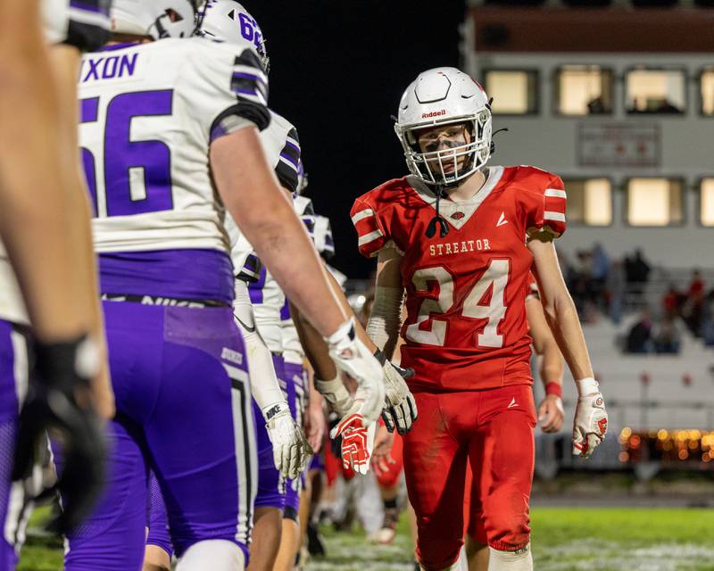 Quintin Stevens (24) of Streator leads team in post game high-five line after major loss to Dixon on Friday, October 17, 2025 at Streator High School in Streator.