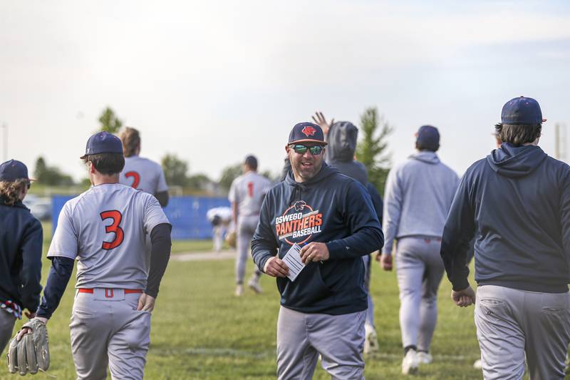 Oswego's head coach Joe Giarrante celebrates the victory over Oswego East with the team after their baseball game at Oswego East. Monday, May 19, 2025 in Oswego.