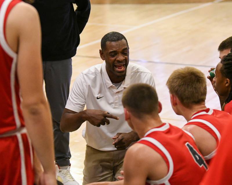 Glenbard East's head coach Eric Kelly talks to the team during a timeout on Wednesday Nov. 26, 2025,during the District 87 Thanksgiving Invitational held at Glenbard West.