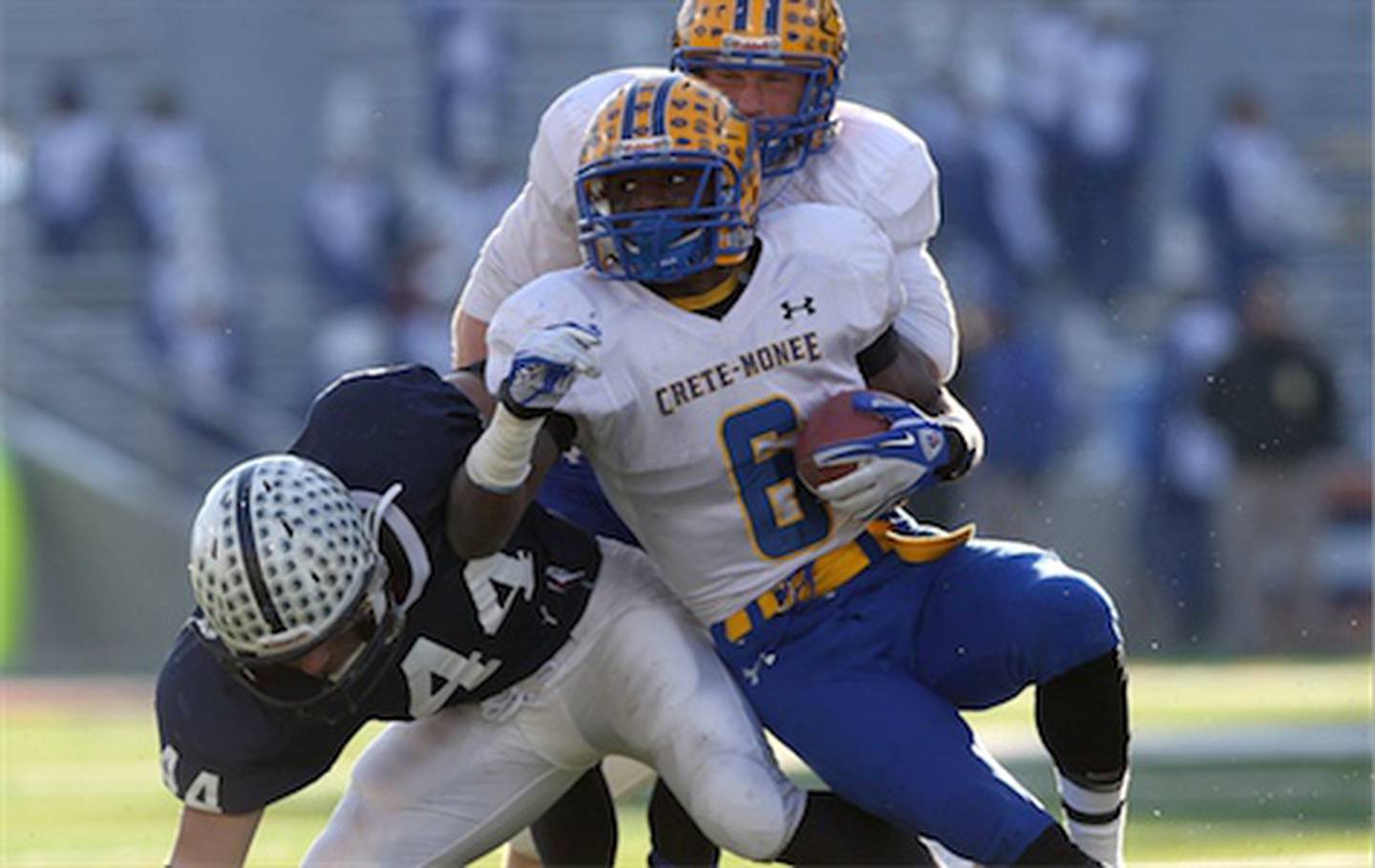 Cary-Grove's Kyle Norberg (left) tries to tackle Crete-Monee's LaQuon Treadwell on Saturday during the third quarter of the Class 6A state championship game at Memorial Stadium in Champaign. C-G lost, 33-26.