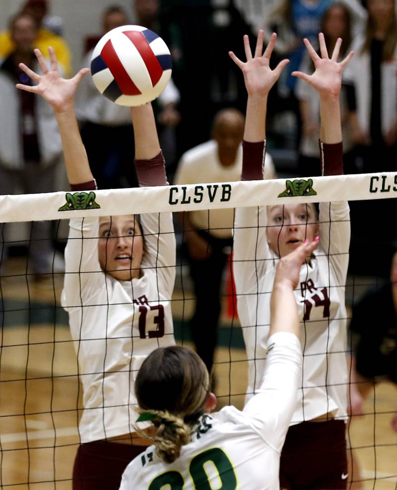 Prairie Ridge's Abigail Smith and Jada Hoyt  trie to block the spike of Crystal Lake South's Morgan Johnson during the IHSA Class 3A Crystal Lake South Sectional final volleyball match on Thursday, Nov. 7, 2024, at Crystal Lake South High School.