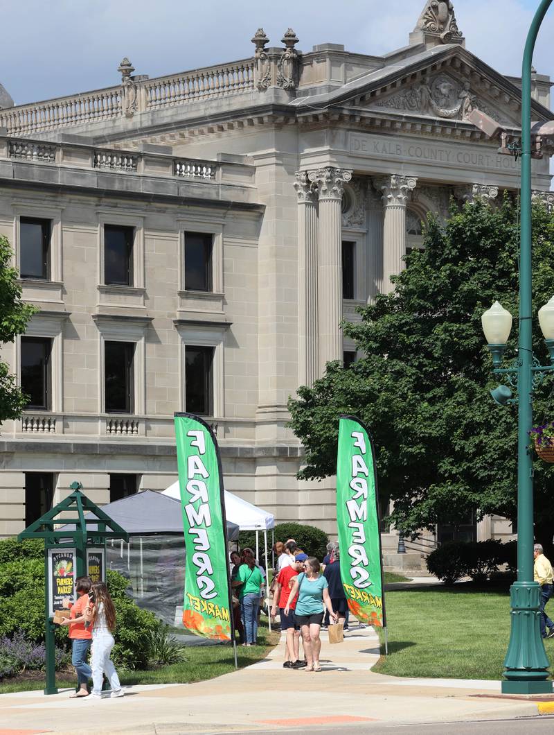 Patrons visit the Sycamore Farmers Market Tuesday, June 7, 2022, at its new location on the lawn of the DeKalb County Courthouse.