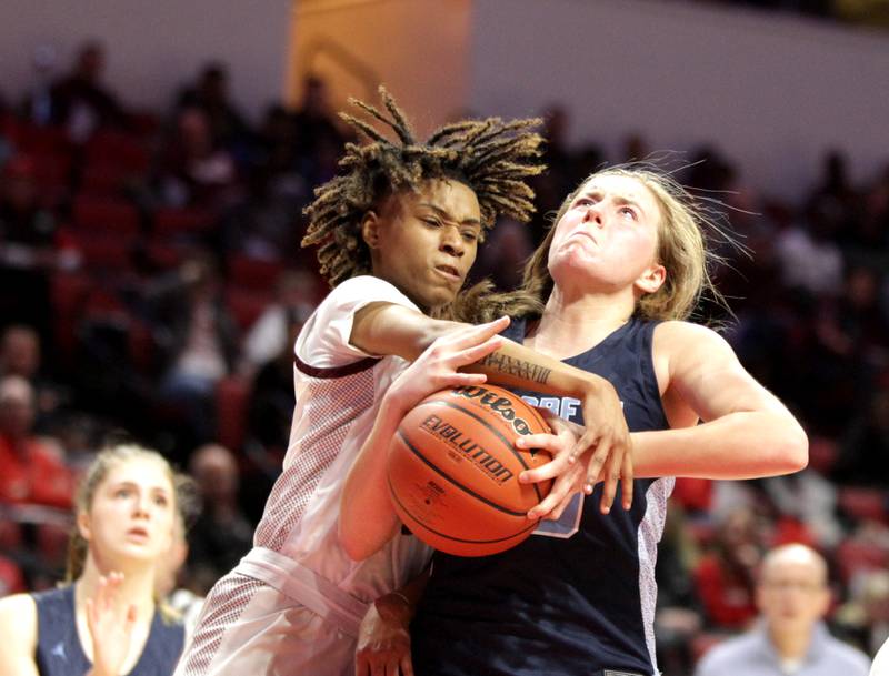 Peoria's Danielle Ruffin (left) tries to knock the ball out of the hand of Nazareth Academy's Amalia Dray (right) during the Class 3A girls basketball state semifinal against Peoria at Redbird Arena in Normal on Friday, March 3, 2023.
