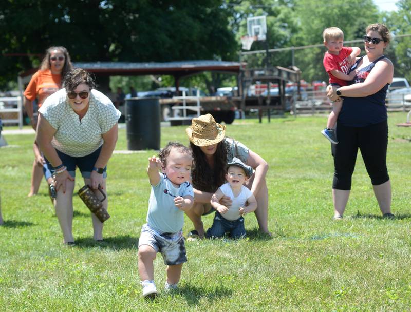 Zayden Haehnel, 14 months, runs to the finish line in the Hooppole Fun Day's Diaper Dash as fellow competitor Cyrus Countryman, 15 months, waits to start on Saturday, June 28, 2025 in Hooppole.