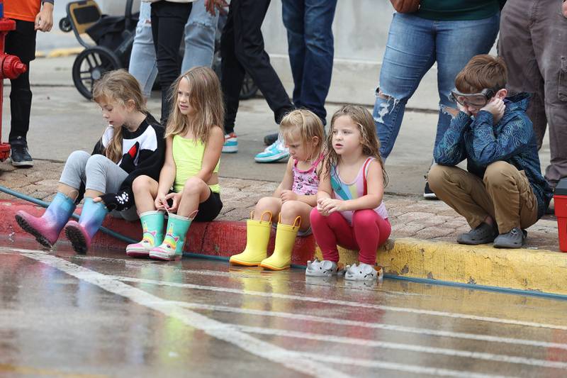 A group of kids watch the Kiddie Water Fight at the 75th Annual Grundy County Corn Festival on Saturday, Sept. 28, 2024 in downtown Morris.