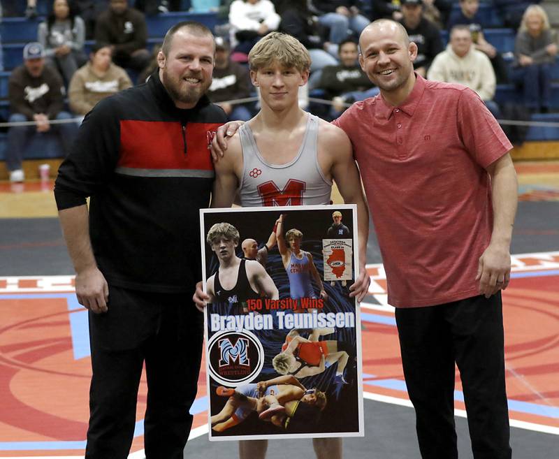 Marian Central's Brayden Teunissen cebretes his 150 career win with coach Jordan Blanton and Ryan Prater during a triangle wrestling meet on Saturday Jan. 11, 2025, between Marian Central, Joliet Catholic, and Mt. Carmel at Marian Central High School in Woodstock.