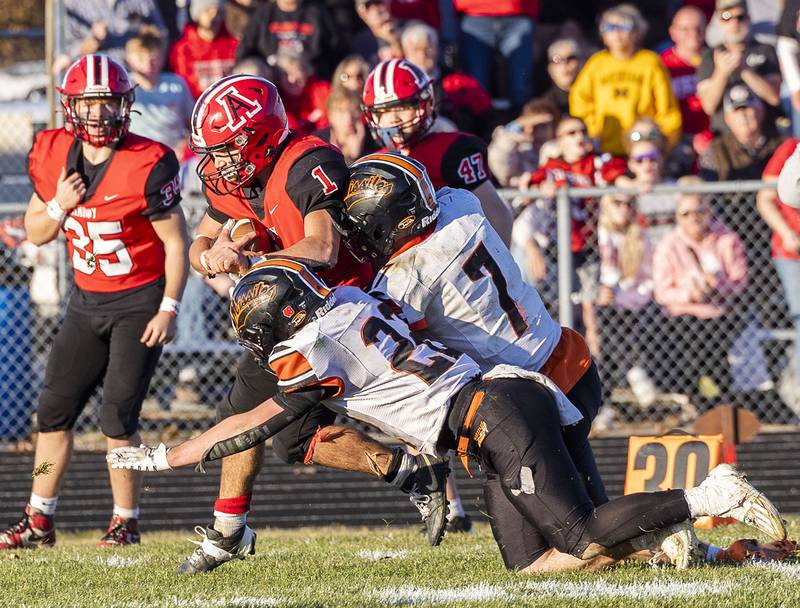 Amboy’s Jose Lopez is run down by Milledgeville’s Jayden Promenschenkel and Konner Johnson Saturday, Nov. 15, 2025, in the 8-man football semifinal.