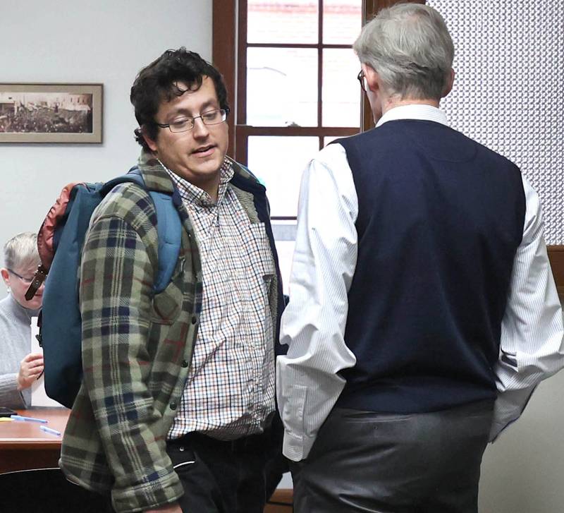 DeKalb City Clerk Sasha Cohen (left) walks past city manager Bill Nicklas Monday, Dec. 12, 2022, at City Hall, after Cohen was informed he would not be the person to accept candidate filings. Filing opened Monday at 8:30 a.m. and Ruth Scott, recording secretary to the DeKalb City Council, was on hand to accept the paperwork for candidates who were filing.