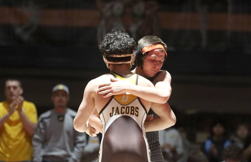 Crystal Lake Central’s Brandon Carbone embraces Jacobs’ Ben Arbotante after their bout at 132 pounds in varsity boys wrestling on Tuesday, Jan. 20, 2026 at Crystal Lake Central High School in Crystal Lake.