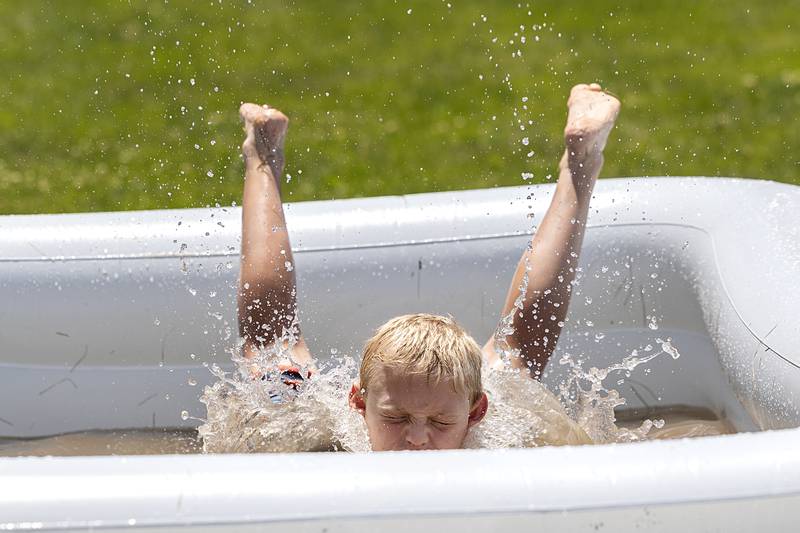 Jackson Wolf, 9, dives into a pool during a spirited game of kick ball Tuesday, June 18, 2024 during Dixon Park District’s SPARK Camp.