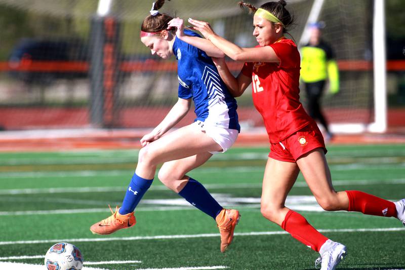 Geneva's Ella Howard and Batavia's Payton Haslett go after the ball during a Tri-Cities Soccer Night game on Tuesday, April 29, 2025 at St. Charles East.