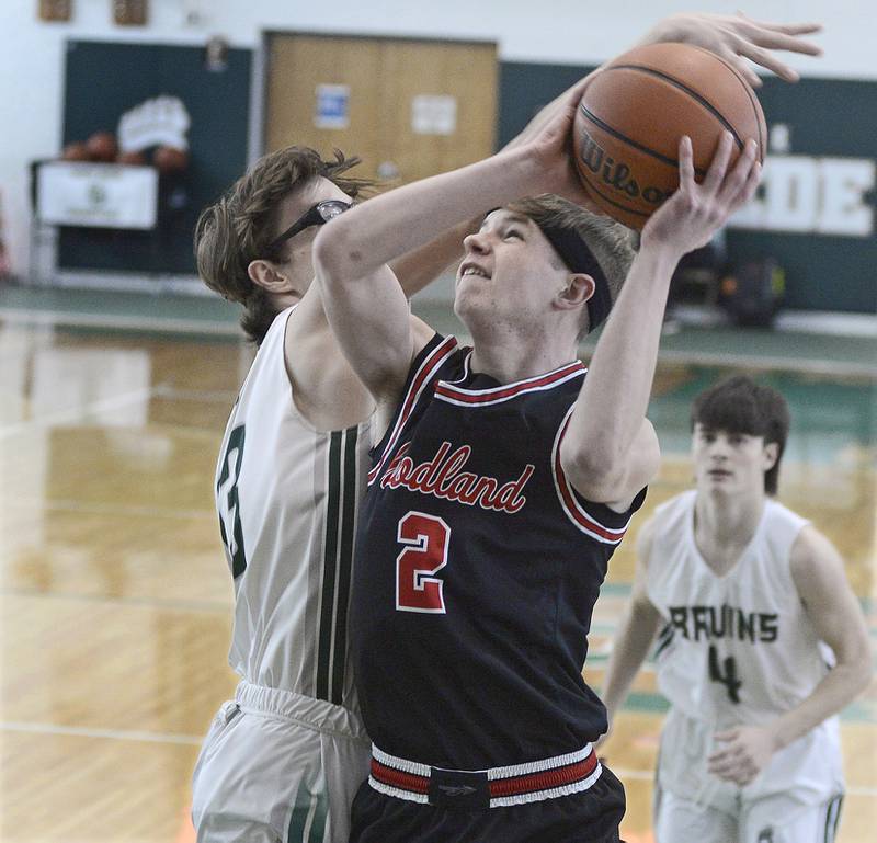 St Bede’s Landon Jackson makes a block attempt on Woodland’s Jon Moore as he works a shot during the 1st period of the Class 1A Regional game on Saturday, Feb. 18, 2023 at St Bede.