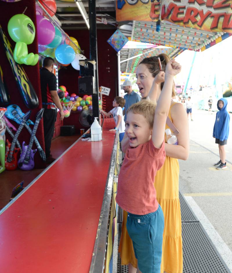 Nash Niemann and his mom Lauren of La Grange Park celebrate him winning a prize during the LaGrange Endless SummerFest Sunday Aug 6, 2023.