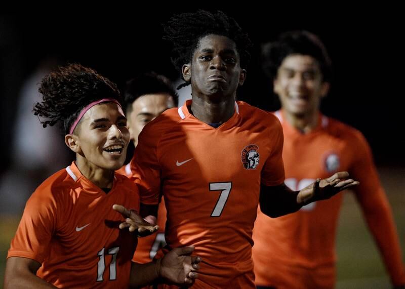 Romeoville’s Christian Agyekum leads his team after scoring the third goal of the first half against York in the Class 3A semifinal game of the boys state soccer tournament in Hoffman Estates on Friday, November, 4, 2022.