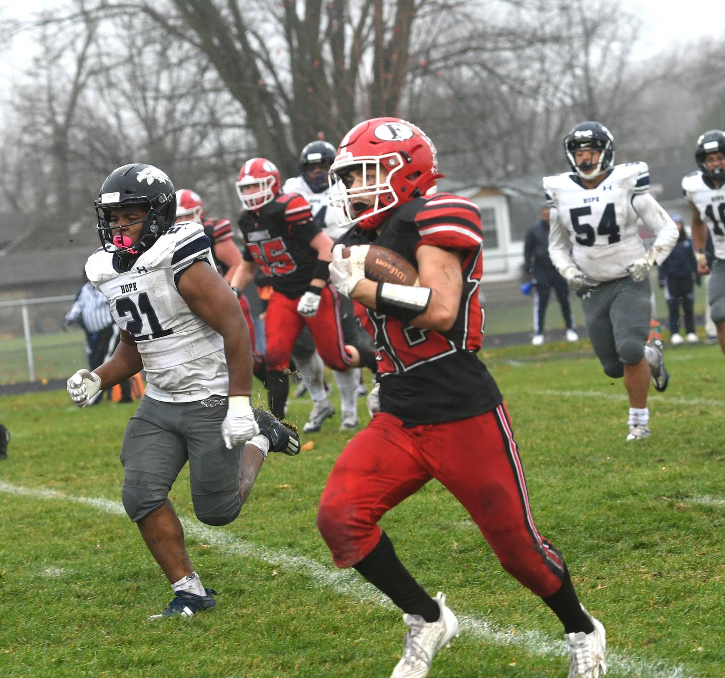 Forreston's Kaleb Sanders runs ahead of Chicago Hope Academy defenders en route to the end zone during 1A playoff action in Forreston on Saturday, Nov. 5. The Cardinals won the game 44-16 to advance to quarterfinals against Dakota.