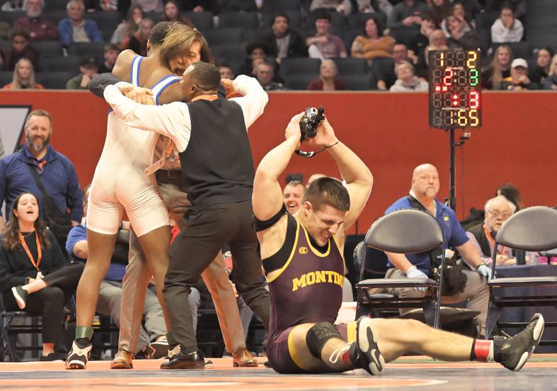 Montini’s Santino Tenuta reacts after losing to East St. Louis’s Pierre Walton, celebrating with his coaches, in the Class 2A 165-pound final at the IHSA boys state wrestling championships at the State Farm Center in Champaign on Saturday, Feb. 22, 2025.