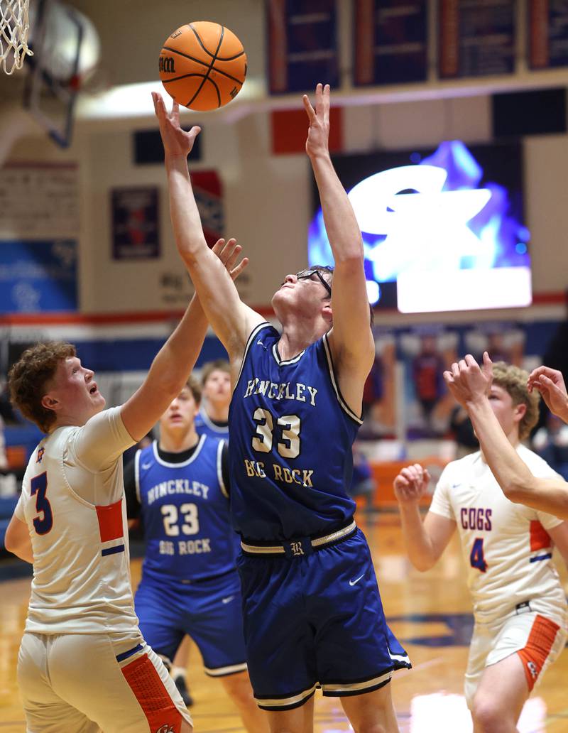 Hinckley-Big Rock's Marshall Ledbetter grabs a rebound over Genoa-Kingston's Jack Peterson Tuesday, Jan. 6, 2026, during their game at Genoa-Kingston High School.