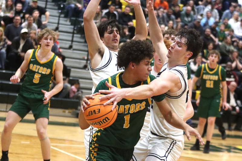 Crystal Lake South’s Noah Cook, front, tries to get past Cary-Grove’s Adam Bauer, right, and Brady Elbert, back, in boys IHSA Class 3A Regional Championship basketball on Friday, Feb. 27, 2026, at Crystal Lake South High School in Crystal Lake.