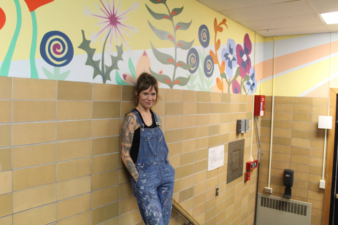 Parent Sara Jean Stevens stand by one of the murals she painted at District 47's North Elementary School in Crystal Lake.