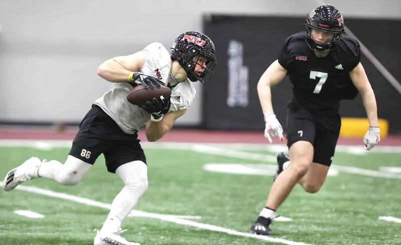 Northern Illinois receiver Trey Urwiler catches a pass in front of Jordan Hansen during the teams first spring practice Wednesday, March 22, 2023, in the Chessick Practice Center at Northern Illinois University in DeKalb.