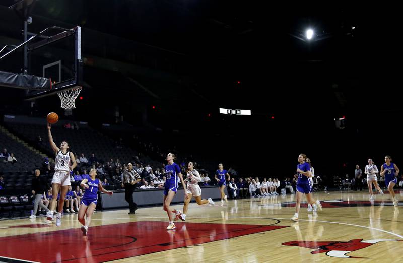 Cary-Grove's Kennedy Manning shoots a lay-up in front of Burlington Central's Kelsey Covey during a Fox Valley Conference basketball game  on Tuesday, Jan. 14, 2025, at Now Arena in Hoffman Estates.