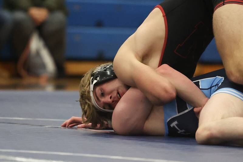 Plainfield North’s Jack Tota works to roll Plainfield South’s Casper Szozda in a Southwest Prairie dual meet on Wednesday, Nov. 29, 2023 in Plainfield.