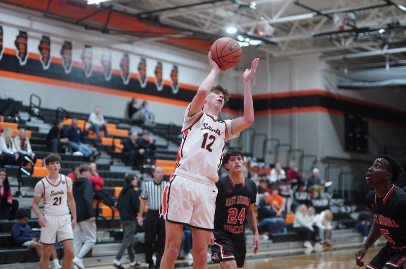 St. Charles East's Sam Tisch (12) shoots the ball in the post against East Aurora during the 64th annual Ron Johnson Thanksgiving Basketball Tournament at St. Charles East High School on Monday, Nov 20, 2023.