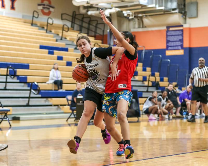 Plano's Josie Larson is fouled on the way to the hoop at the Oswego girls basketball shootout tournament. June 28, 2024.