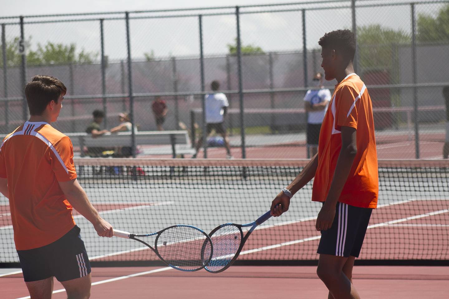 Oswego doubles pair Barry King (right) and Stefan Ninic (left) congratulate each other after a point during boys' conference tennis May 26 at Plainfield North High School.